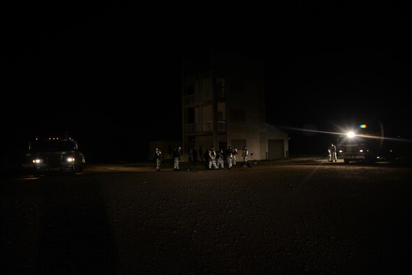 The 47th Civil Engineer Squadron prepares for structural live-fire training on Laughlin Air Force Base, Texas, Nov. 18, 2015. Using an offensive firefighting tactic, the goal was to estinguish the fire as quickly, safely and efficiently as possible. (U.S. Air Force photo by Airman 1st Class Brandon May)