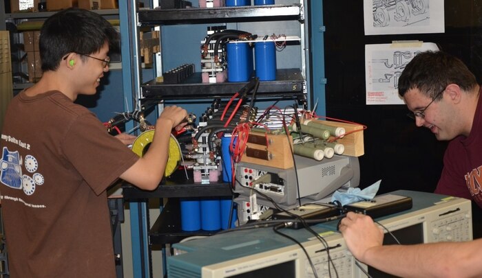 BLACKSBURG, Va. - Virginia Tech students studying electromagnetic railgun technology are pictured during a break in their work at the university's Energy Conversion Systems Laboratory. Naval Surface Warfare Center Dahlgren Division scientists and engineers mentored the students who fired Virginia Tech's electromagnetic railgun for the first time Dec. 4. The university's reduced-scale railgun program attracted more than 150 students from all engineering disciplines to participate in hands-on railgun research.