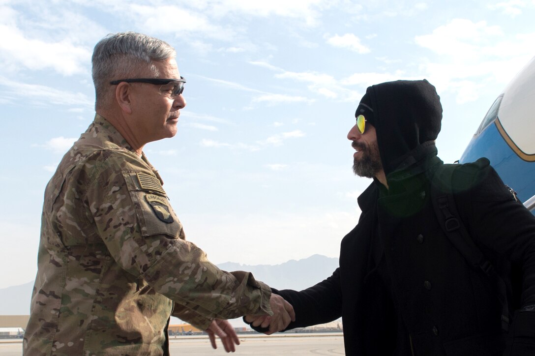 U.S. Army Gen. John F. Campbell, commander of U.S. Forces-Afghanistan and the Resolute Support Mission, greets musician Chris Daughtry as he arrives at Bagram Airfield, Afghanistan, Dec. 8, 2015. Daughtry was traveling as part of the 2015 USO Holiday Tour to visit deployed service members. DoD photo by D. Myles Cullen