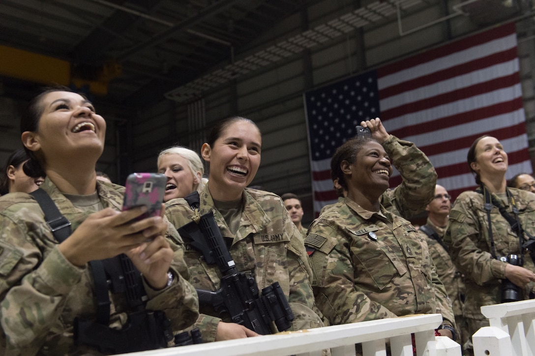 U.S. service members cheer during a performance by members of the 2015 USO Holiday Tour at Bagram Airfield, Afghanistan, Dec. 8, 2015. DoD photo by D. Myles Cullen