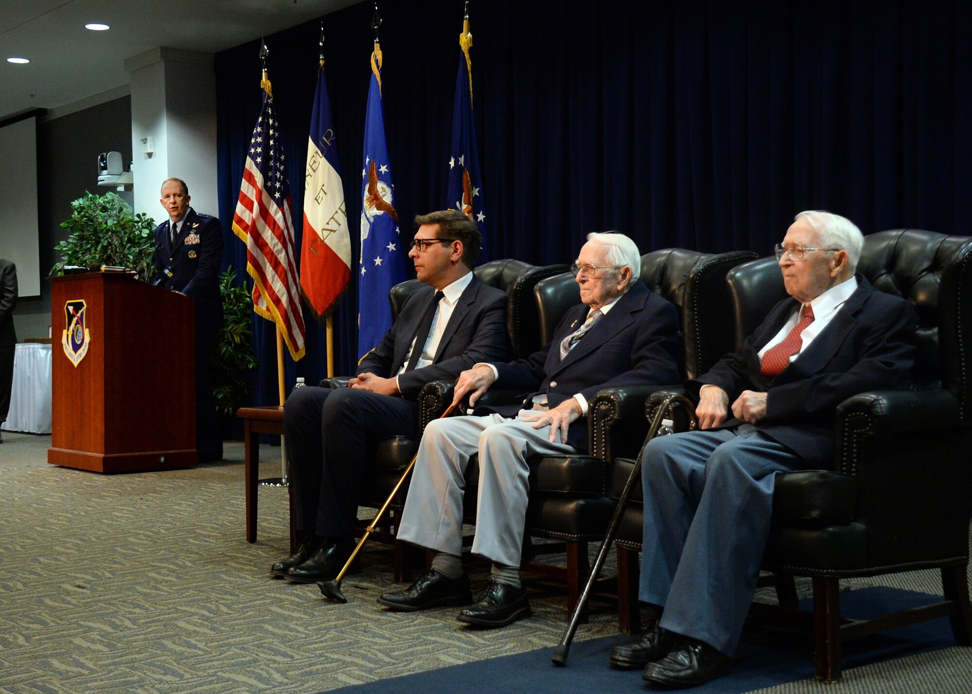 Maj. Gen. Robert D. McMurry Jr., the Space and Missile Systems Center vice commander, addresses the audience as Christophe Lemoine, the French consul general in Los Angeles, prepares to present identical twin brothers and retired Air Force Reserve Majs. Russell “Lynn” Clanin and Raymond “Glenn” Clanin with the French government's highest distinction for their military service as World War II veterans, the Legion of Honor medal. (U.S. Air Force photo/Van De Ha)