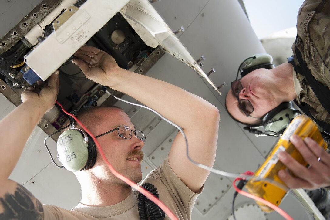 U.S. Air Force Staff Sgt. Brendan Lee, left, and U.S. Air Force Senior Airman Travis Legg troubleshoot an F-16 Fighting Falcon aircraft with a faulty radar module on Bagram Airfield, Afghanistan, Nov. 30, 2015. Lee and Legg are avionics technicians assigned to the 455th Expeditionary Aircraft Maintenance Squadron, deployed from Hill Air Force Base, Utah. U.S. Air Force photo by Tech. Sgt. Robert Cloys