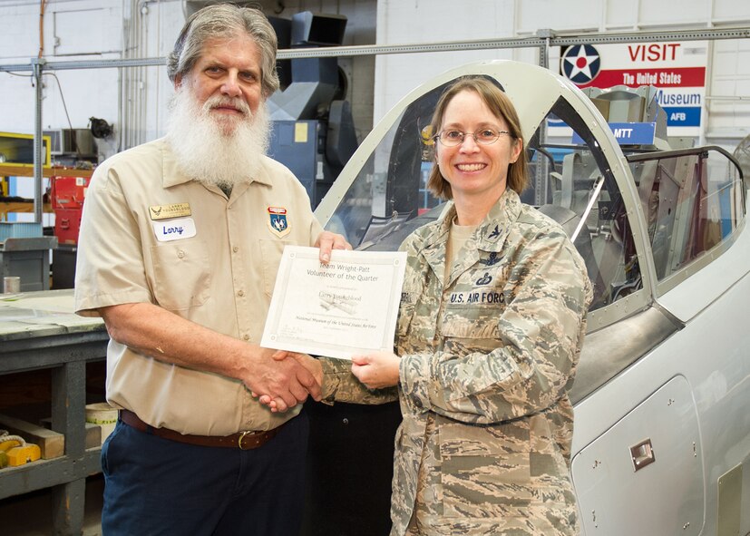 88th Air Base Wing Vice Commander Col. Elena M. Oberg (right) presented Englewood resident Larry Youngblood with the Team Wright-Patt “Volunteer of the Quarter” award for the third quarter of 2015 on Dec. 9, 2015. (U.S. Air Force photo) 