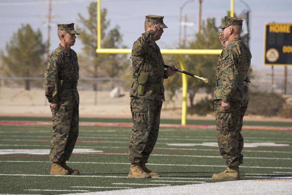 Sgt. Maj. Abel T. Leal, outgoing battalion sergeant major, Headquarters Battalion, performs the passing of the non-commissioned officer sword to Sgt. Maj. Avery L. Crespin, oncoming battalion sergeant major, Headquarters Battalion, during a relief and appointment ceremony at Felix Field, Dec. 3, 2015. (Official Marine Corps photo by Pfc. Allie Jesse/Released)