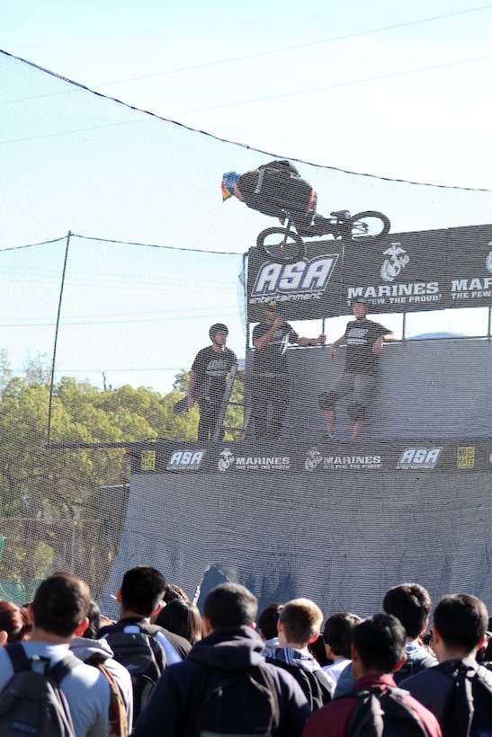 Students of Santa Paula High School watch as BMX rider Coco Zuria shows off his half-pipe skills during an ASA High School Tour event with Marines from Recruiting Sub Station Ventura at the high school, Dec. 8, 2015, in Santa Paula, Calif. ASA brings in five of the world's top professional skateboarders, inline skaters and BMX riders from the X Games to perform on a state-of-the art half-pipe. Marines from RSS Ventura supported the event to inform students about the Marine Corps. (U.S. Marine Corps photo by Staff Sgt. Alicia R. Leaders/Released)