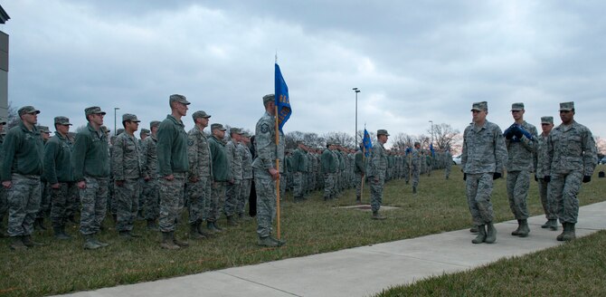 Airmen from the National Air and Space Intelligence Center’s Color Guard retire the flag during a retreat ceremony at Wright-Patterson Air Force Base, Ohio, Dec. 7, 2015. The retreat ceremony serves a twofold purpose it signals the end of the official duty day and serves as a ceremony for paying respect to the United States flag.  (U.S. Air Force Photo by Senior Airman Samuel Earick)   