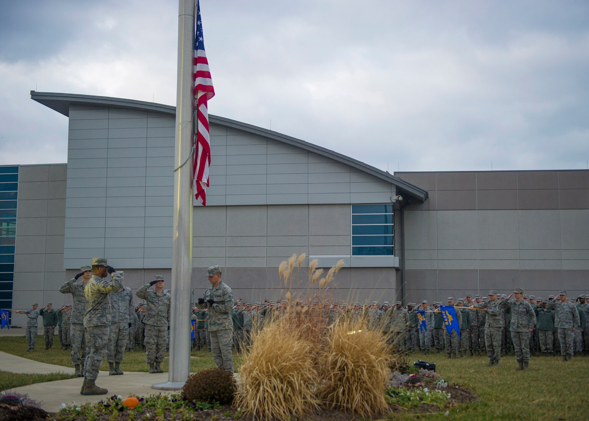 Airmen from the National Air and Space Intelligence Center’s Color Guard lower the flag during a retreat ceremony, 74 years after the attack on Pearl Harbor at Wright-Patterson Air Force Base, Ohio, Dec. 7, 2015. The retreat ceremony serves a twofold purpose it signals the end of the official duty day and serves as a ceremony for paying respect to the United States flag. (U.S. Air Force Photo by Senior Airman Justyn M. Freeman)   
