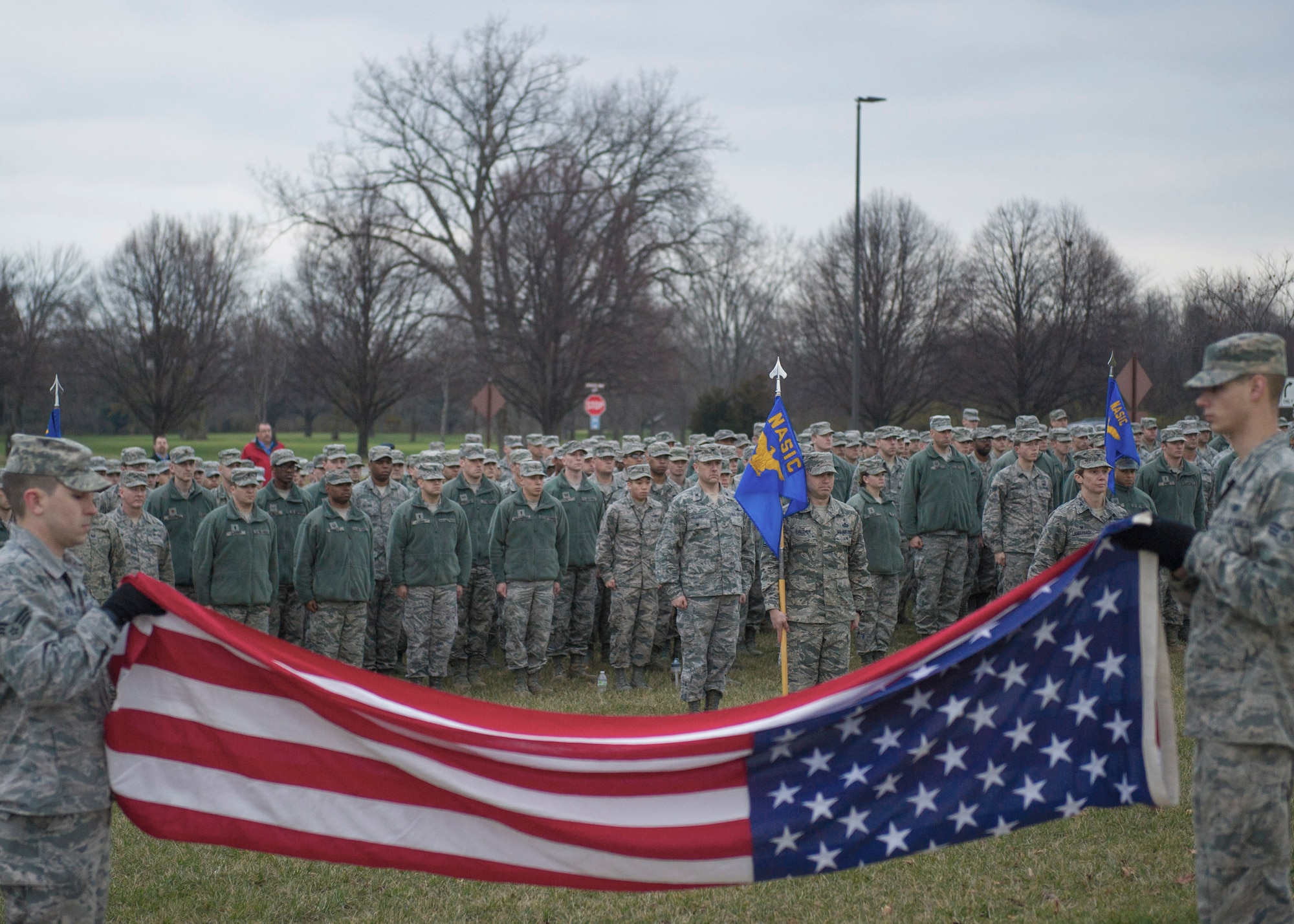 Airmen from the National Air and Space Intelligence Center Color Guard fold the flag during a retreat ceremony, 74 years after the attack on Pearl Harbor at Wright-Patterson Air Force Base, Ohio, Dec. 7, 2015. The retreat ceremony serves a twofold purpose it signals the end of the official duty day and serves as a ceremony for paying respect to the United States flag. (U.S. Air Force Photo by Senior Airman Justyn M. Freeman)   