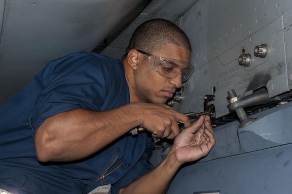 U.S. Air Force Airman 1st Class Brandon Martel, 67th Aircraft Maintenance Unit avionics technician apprentice, secures safety wire for a sniper pod on an F-15C Eagle, Dec. 8, 2015, at Kadena Air Base, Japan. The safety wire and attached pin ensure the sniper pod cannot be accidently jettisoned during flight. (U.S. Air Force photo by Airman Zackary A. Henry)
