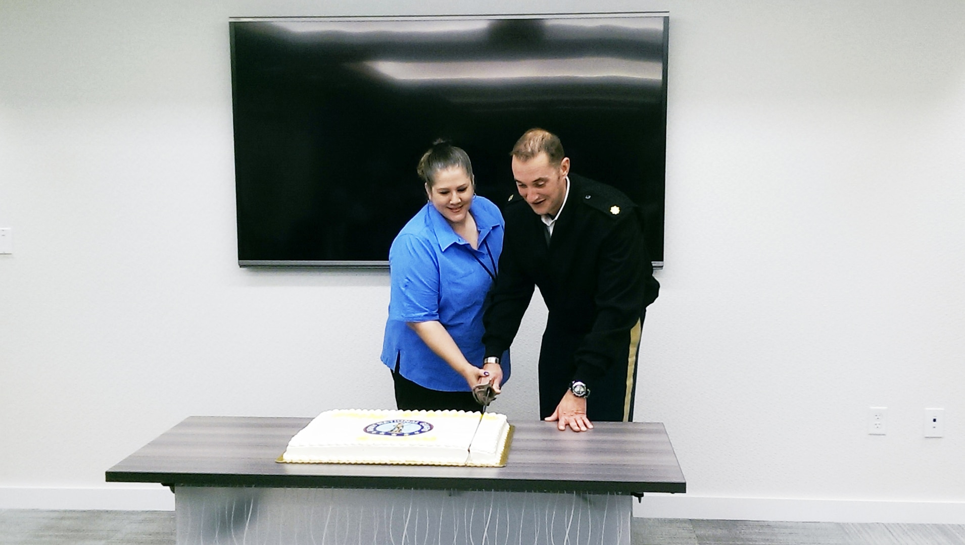 Cake-cutting celebrates GuardNet's 15-year hstory. Doing the honors are contractor Mary Proffitt, longest-tenured employee with more 15 years, and Maj. Shannon Huntley, tactical communications branch, Tactical Branch.
