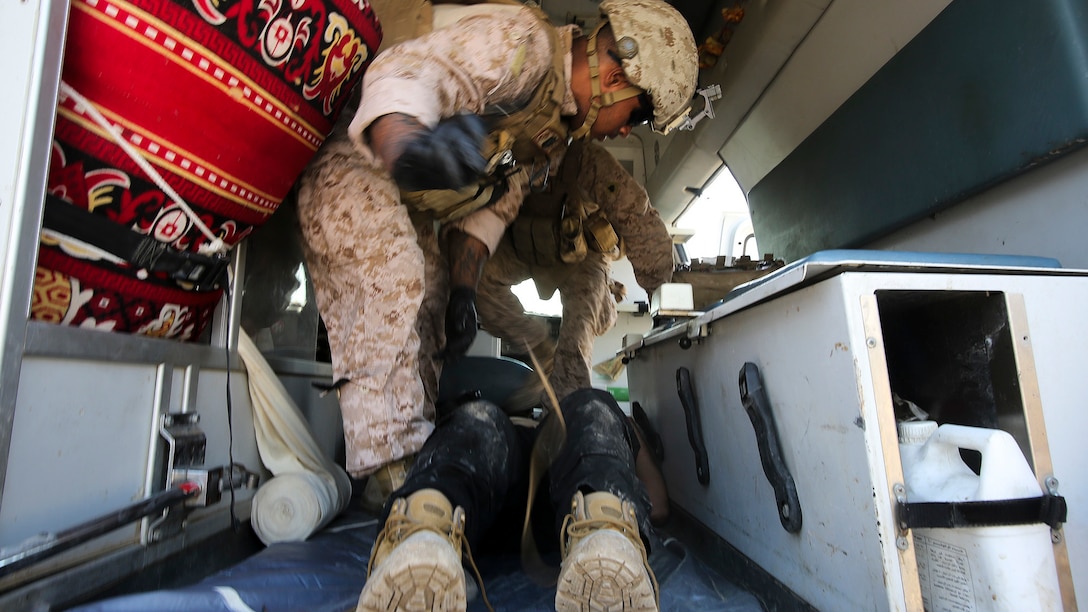 U.S. Navy Seaman Apprentice Mikail Garib, a hospitalman with Company B, 1st Battalion, 7th Marine Regiment, Special Purpose Marine Air Ground Task Force – Crisis Response – Central Command, treats an Iraqi soldier for combat-related injuries at Al Taqaddum, Iraq, Nov. 28, 2015. Wounded Iraqi soldiers are occasionally transported from battlefields in Ramadi and Fallujah, Iraq, to Al Taqaddum to receive medical treatment from U.S. personnel. U.S. Navy corpsmen with “Bravo” Company, 1st Bn., 7th Marines, are the first responders to attend to the casualties. U.S. Marines and sailors with SPMAGTF-CR-CC are currently deployed in support of Combined Joint Task Force - Operation Inherent Resolve, which focuses on defeating the Islamic State of Iraq and Levant in the U.S. Central Command area of responsibility. 