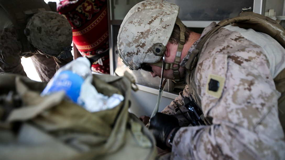U.S. Navy Petty Officer 3rd Class Bryan Rileysilva, a hospitalman with Company B, 1st Battalion, 7th Marine Regiment, Special Purpose Marine Air Ground Task Force – Crisis Response – Central Command, treats an Iraqi soldier for combat-related injuries at Al Taqaddum, Iraq, Nov. 28, 2015. Wounded Iraqi soldiers are occacionally transported from battlefields in Ramadi and Fallujah, Iraq, to Al Taqaddum to receive medical treatment from U.S. personnel. U.S. Navy corpsmen with “Bravo” Company, 1st Bn., 7th Marines, are the first responders to attend to the casualties. U.S. Marines and sailors with SPMAGTF-CR-CC are currently deployed in support of Combined Joint Task Force - Operation Inherent Resolve, which focuses on defeating the Islamic State of Iraq and Levant in the U.S. Central Command area of responsibility. 