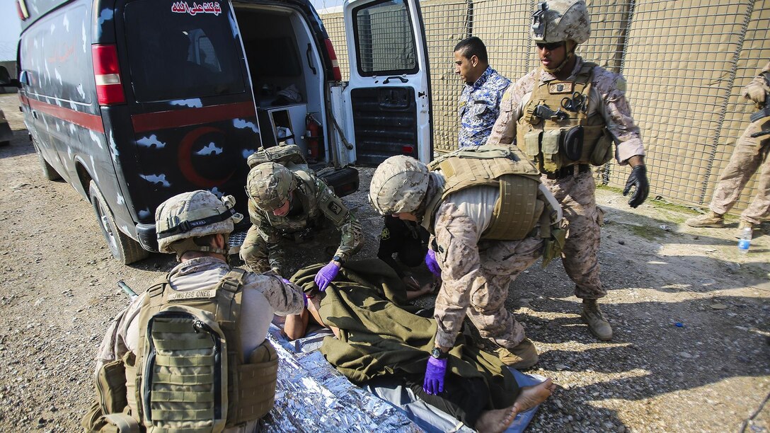 U.S. Navy corpsmen with Company B, 1st Battalion, 7th Marine Regiment, Special Purpose Marine Air Ground Task Force – Crisis Response – Central Command, and a member of the U.S. Army 772nd Forward Surgical Team, attached to Task Force Al Taqaddum, prepare an Iraqi soldier that sustained combat-related injuries for transport to the 115th Combat Support Hospital, attached to Task Force Al Taqaddum, Iraq, Nov. 28, 2015. Wounded Iraqi soldiers are occasionally transported from battlefields in Ramadi and Fallujah, Iraq, to Al Taqaddum to receive medical treatment from U.S. personnel. U.S. Navy corpsmen with “Bravo” Company, 1st Bn., 7th Marines, are the first responders to attend to the casualties. 