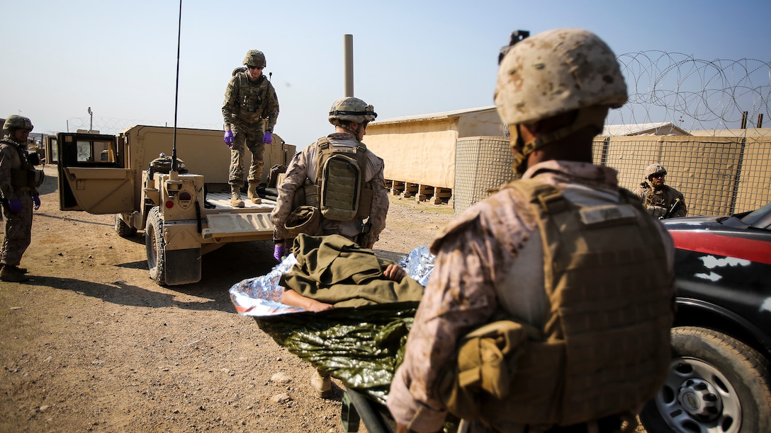 U.S. Navy corpsmen with Company B, 1st Battalion, 7th Marine Regiment, Special Purpose Marine Air Ground Task Force – Crisis Response – Central Command, and a member of the U.S. Army 772nd Forward Surgical Team, attached to Task Force Al Taqaddum, aid an Iraqi soldier that sustained combat-related injuries, Iraq, Nov. 28, 2015. Wounded Iraqi soldiers are occasionally transported from battlefields in Ramadi and Fallujah, Iraq, to Al Taqaddum to receive medical treatment from U.S. personnel. U.S. Navy corpsmen with “Bravo” Company, 1st Bn., 7th Marines, are the first responders to attend to the casualties. U.S. Marines and Sailors with SPMAGTF-CR-CC are currently deployed in support of Combined Joint Task Force - Operation Inherent Resolve, which focuses on defeating the Islamic State of Iraq and Levant and the threat they pose to Iraq, Syria, the region and the wider international community. 