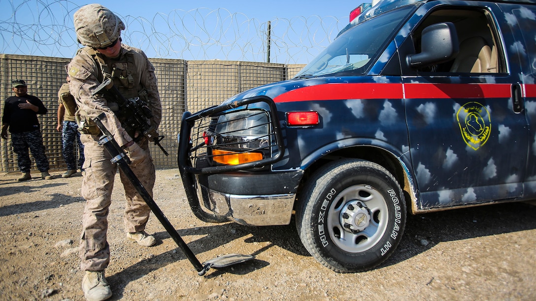 A U.S. Marine with Company B, 1st Battalion, 7th Marine Regiment, Special Purpose Marine Air Ground Task Force – Crisis Response – Central Command, searches an ambulance carrying an injured Iraqi soldier at Al Taqaddum, Iraq, Nov. 28, 2015. Wounded Iraqi soldiers are occasionally transported from battlefields in Ramadi and Fallujah, Iraq, to Al Taqaddum to receive medical treatment from U.S. personnel. U.S. Navy with “Bravo” Company, 1st Bn., 7th Marines, are the first responders to attend to the casualties. 