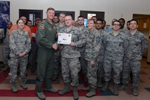 Senior Airman Steven Lowrance, center, 47th Security Forces Squadron vehicle control officer, poses with Col. Thomas Shank, left, 47th Flying Training Wing commander, and Chief Master Sgt. Teresa Clapper, 47th FTW command chief, after accepting the “XLer of the Week” award, here, Dec. 2, 2015. The XLer is a weekly award chosen by wing leadership and is presented to those who consistently make outstanding contributions to their unit and Laughlin. (U.S. Air Force photo by Senior Airman Jimmie D. Pike)