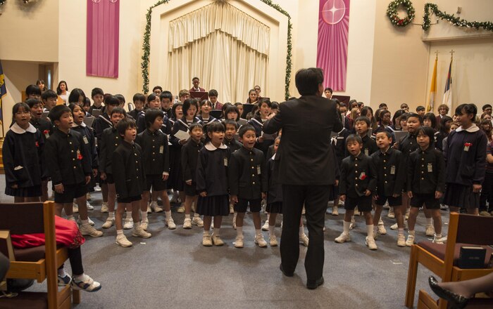 Japanese students from Migama Elementary School and Kawashimo Junior High School sing a holiday carol during the annual holiday concert at Marine Memorial Chapel at Marine Corps Air Station Iwakuni, Japan, Dec. 8, 2015. Traditionally, M.C. Perry School invites local Japanese schools to participate in the concert affording the students the opportunity to interact with one another.