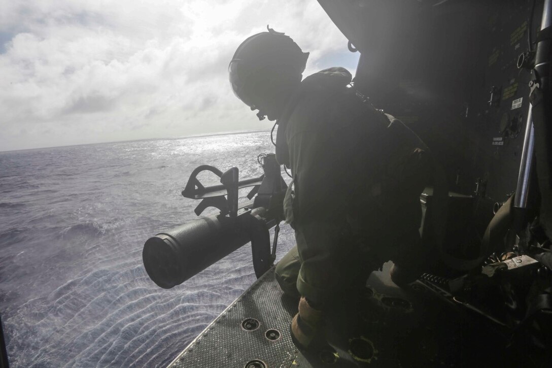 PACIFIC OCEAN  (Nov. 30, 2015) U.S. Marine Cpl. Cody L. Daniel relays altitude information to the pilots of a UH-1Y Venom. Daniel is a crew chief with Marine Medium Tiltrotor Squadron 161, 15th Marine Expeditionary Unit. The 15th MEU is currently deployed in the Indo-Asia-Pacific region to promote regional stability and security in the U.S. 7th Fleet area of operations. (U.S. Marine Corps photo by Sgt. Jamean Berry/Released)