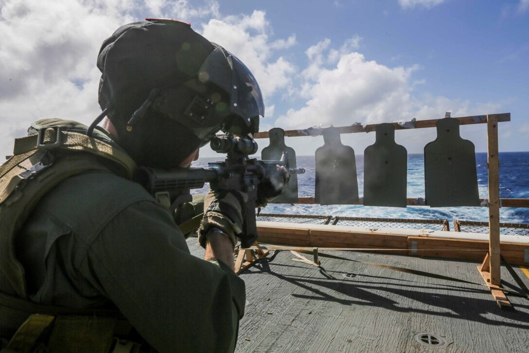 PACIFIC OCEAN (Dec. 2, 2015) U.S. Marine Capt. Andrew Behrends fires an M4 carbine during a deck shoot aboard the USS Anchorage (LPD 23).   Behrends is an AH-1Z pilot with Marine Medium Tiltrotor Squadron 161 (Reinforced), 15th Marine Expeditionary Unit.  The 15th MEU is currently returning from a routine seven-month deployment to the US Pacific and Central Command areas of responsibility. (U.S. Marine Corps photo by Sgt. Jamean Berry/Released)