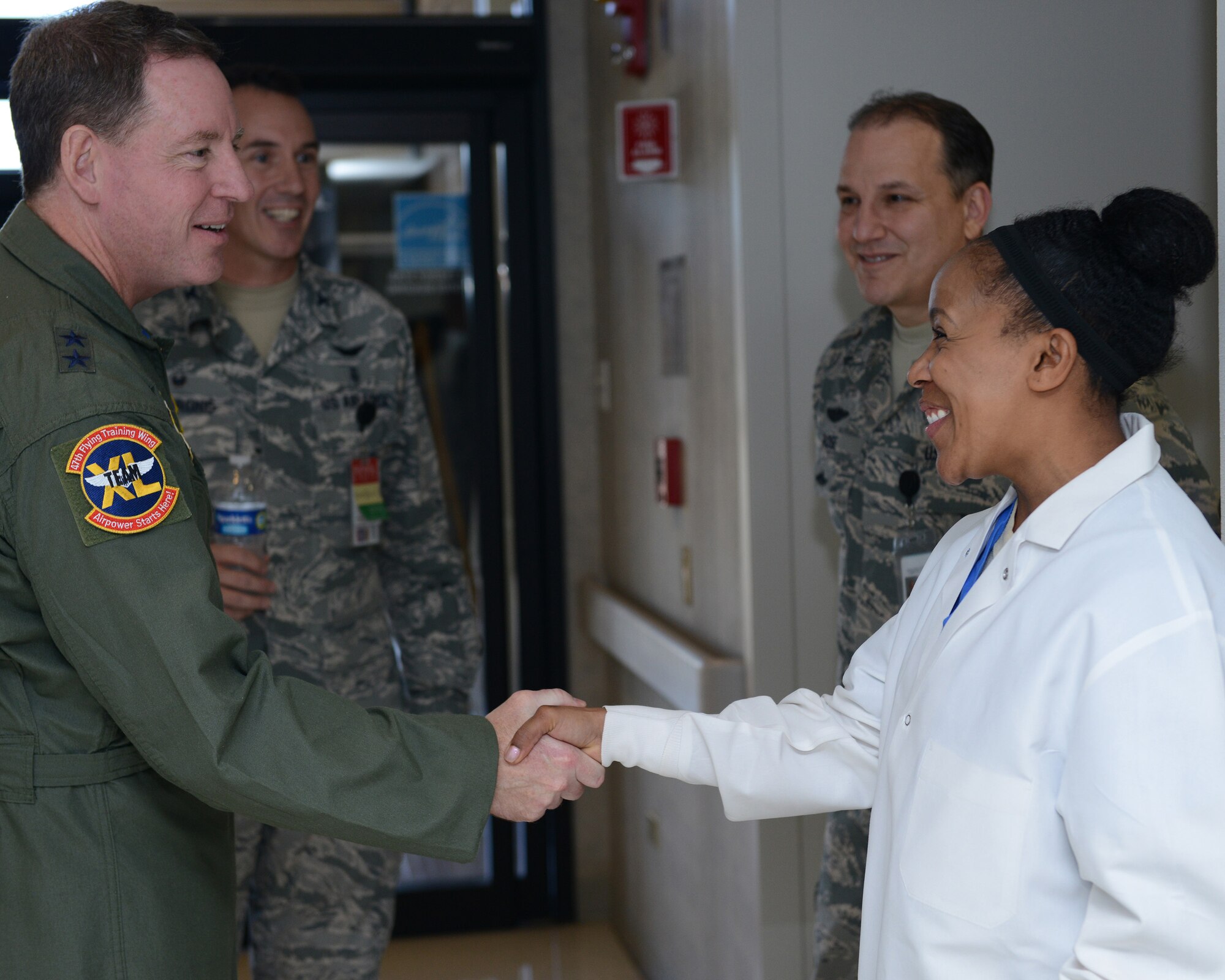 Maj. Gen. James Hecker, 19th Air Force commander, meets with Staff Sgt. Halima Burton, 47th Medical Operations Support Squadron dental hygienist, at Laughlin Air Force Base, Texas, Dec. 4, 2015. During his visit to Laughlin, Hecker toured the medical facility and spoke with personnel about programs and procedures they use. (U.S. Air Force photo by Senior Airman Jimmie D. Pike)