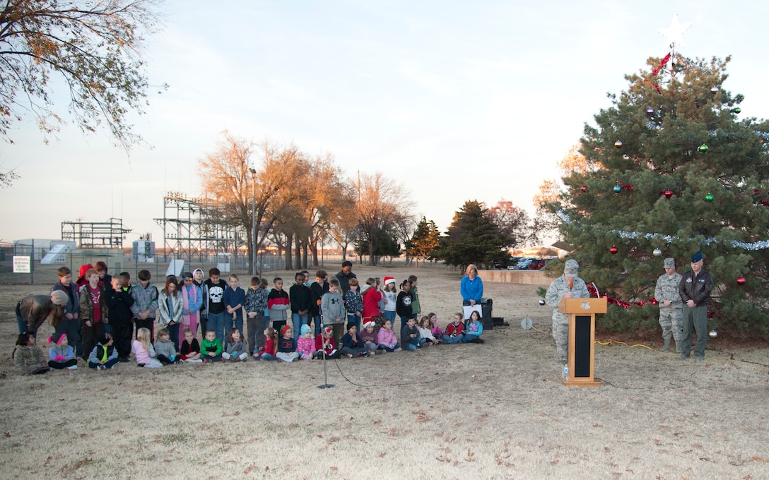 Chaplain (Maj.) Randall Groves, the Base Chaplain, thanks children from Eisenhower Elementary and their parents for joining Col. James Lackey, the 71st Flying Training Wing commander, and the Base Chapel staff for the Base Christmas Tree Lighting Dec. 7. (U.S. Air Force photo / Tech. Sgt. James Bolinger)