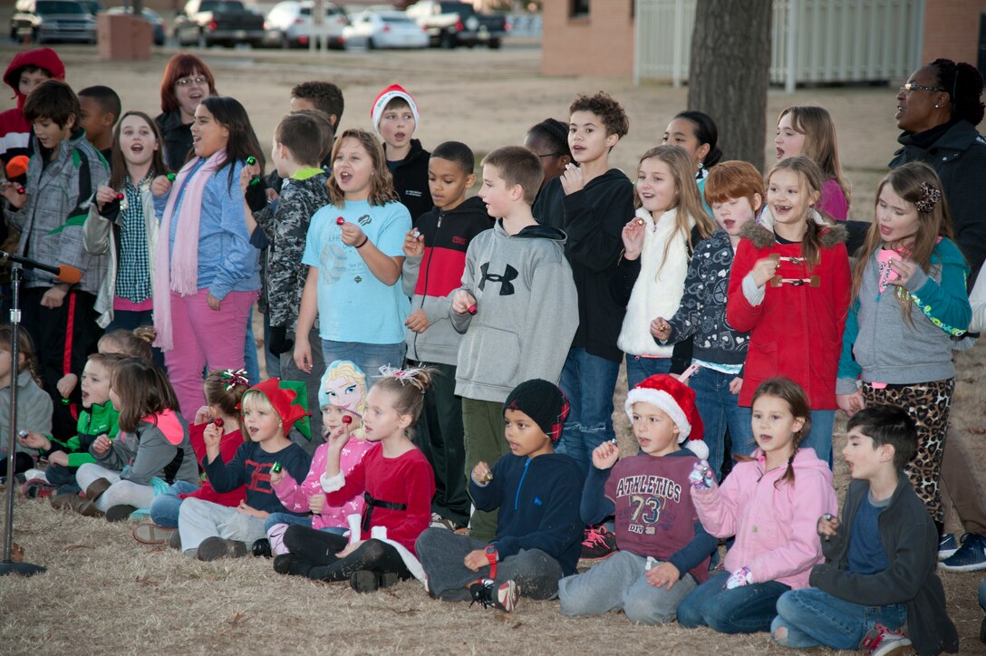 Students from Eisenhower Elementary sing Christmas carols for their families during the Base Christmas Tree lighting Dec. 7. The lighting of the base tree is an annual event and Eisenhower students sing carols every year. (U.S. Air Force photo / Tech. Sgt. James Bolinger)