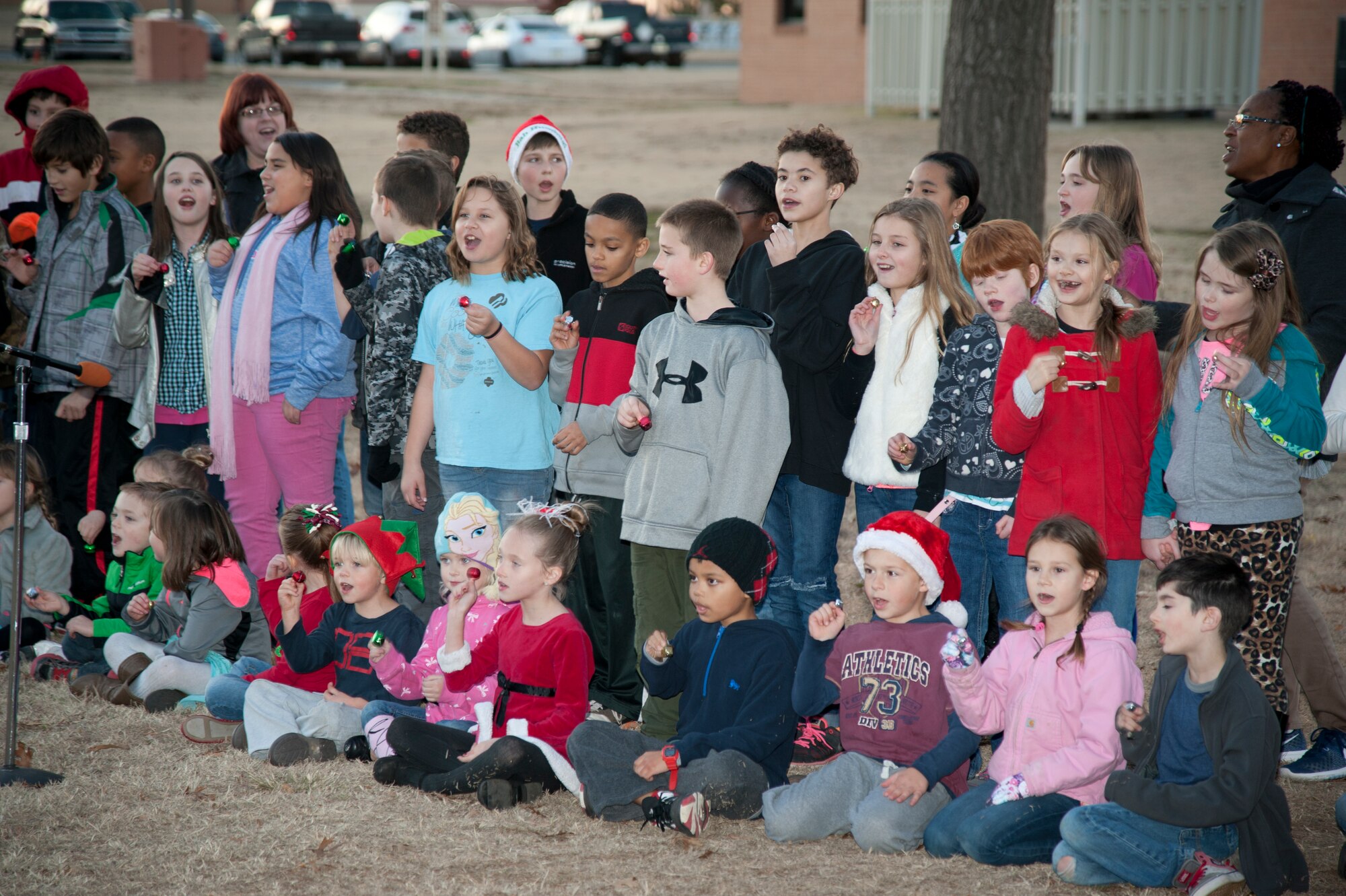 Students from Eisenhower Elementary sing Christmas carols for their families during the Base Christmas Tree lighting Dec. 7. The lighting of the base tree is an annual event and Eisenhower students sing carols every year. (U.S. Air Force photo / Tech. Sgt. James Bolinger)
