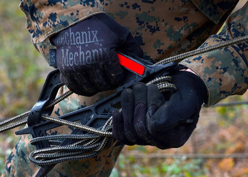 A U.S. Marine assigned to the 273rd Marine Wing Support Squadron pulls a rope tight, securing a communications tower in preparation for an exercise at Poinsett Electronic Combat Range, Wedgefield, S.C., Dec. 7, 2015. The Marines were a part of the setup team preparing for a week long exercise. (U.S. Air Force photo by Senior Airman Michael Cossaboom)