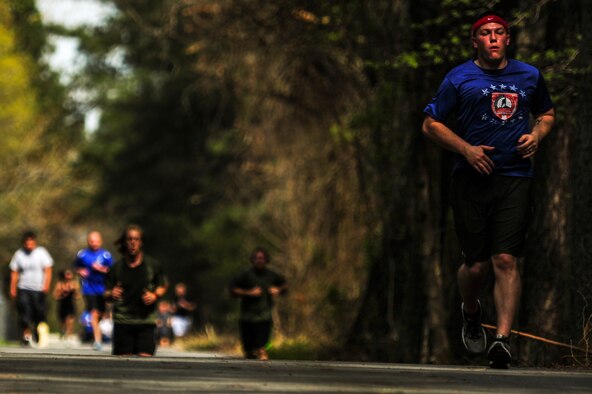 Members of Team Seymour near the finish line during a 5K Fun Run, April 3, 2015, at Seymour Johnson Air Force Base, North Carolina. The run was held in support of a Team Seymour Airman who suffered debilitating injuries during an accident. (U.S Air Force photo/Senior Airman Brittain Crolley)