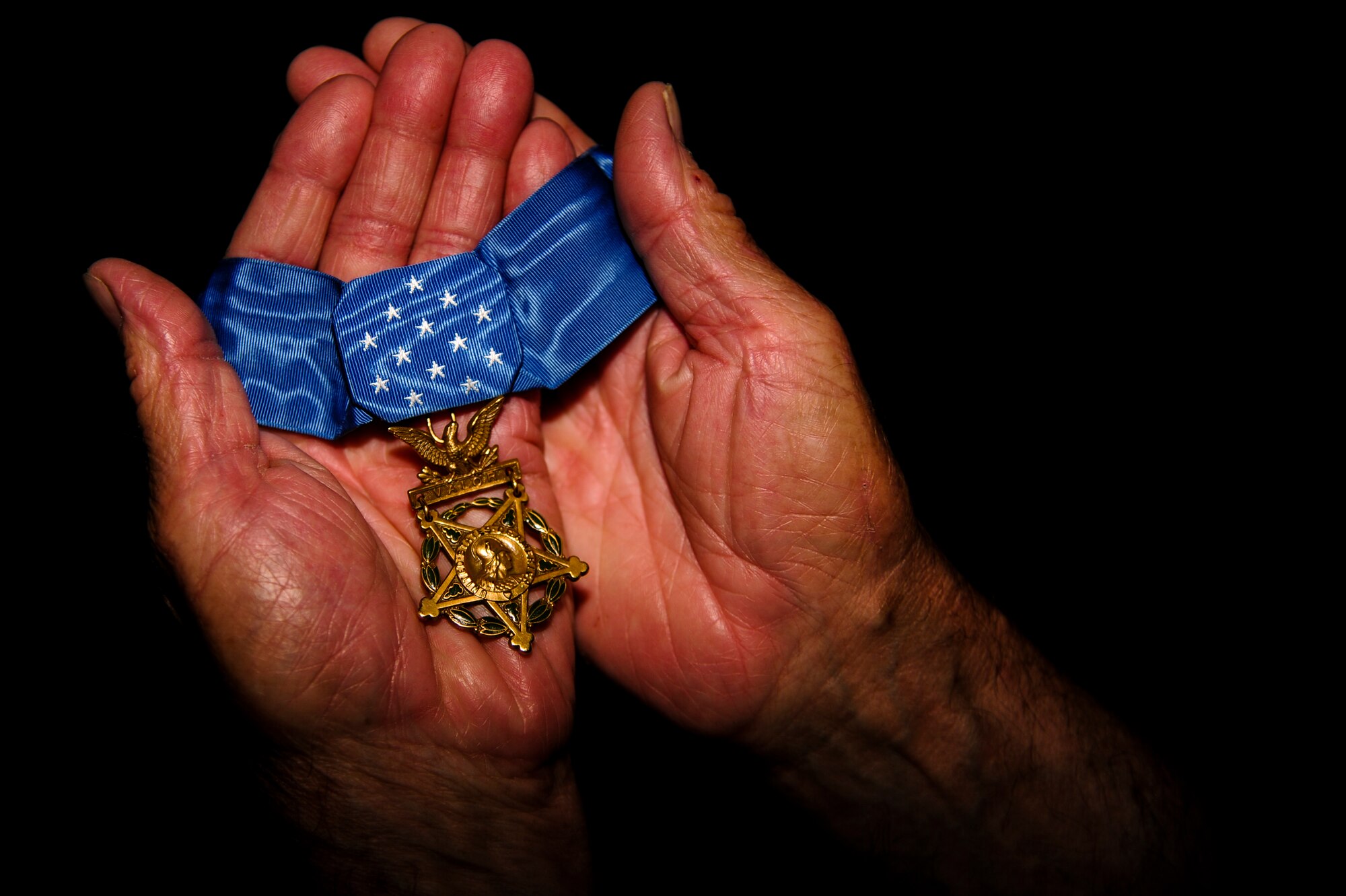 Retired U.S. Army Col. Walter “Joe” Marm cradles his Medal of Honor, June 30, 2015, at his house in Fremont, North Carolina. Marm was awarded the Congressional Medal of Honor for his actions during the Battle of la Drang, where he single-handedly attacked an enemy position in order to save the lives of his platoon members. (U.S. Air Force photo/Senior Airman Brittain Crolley)