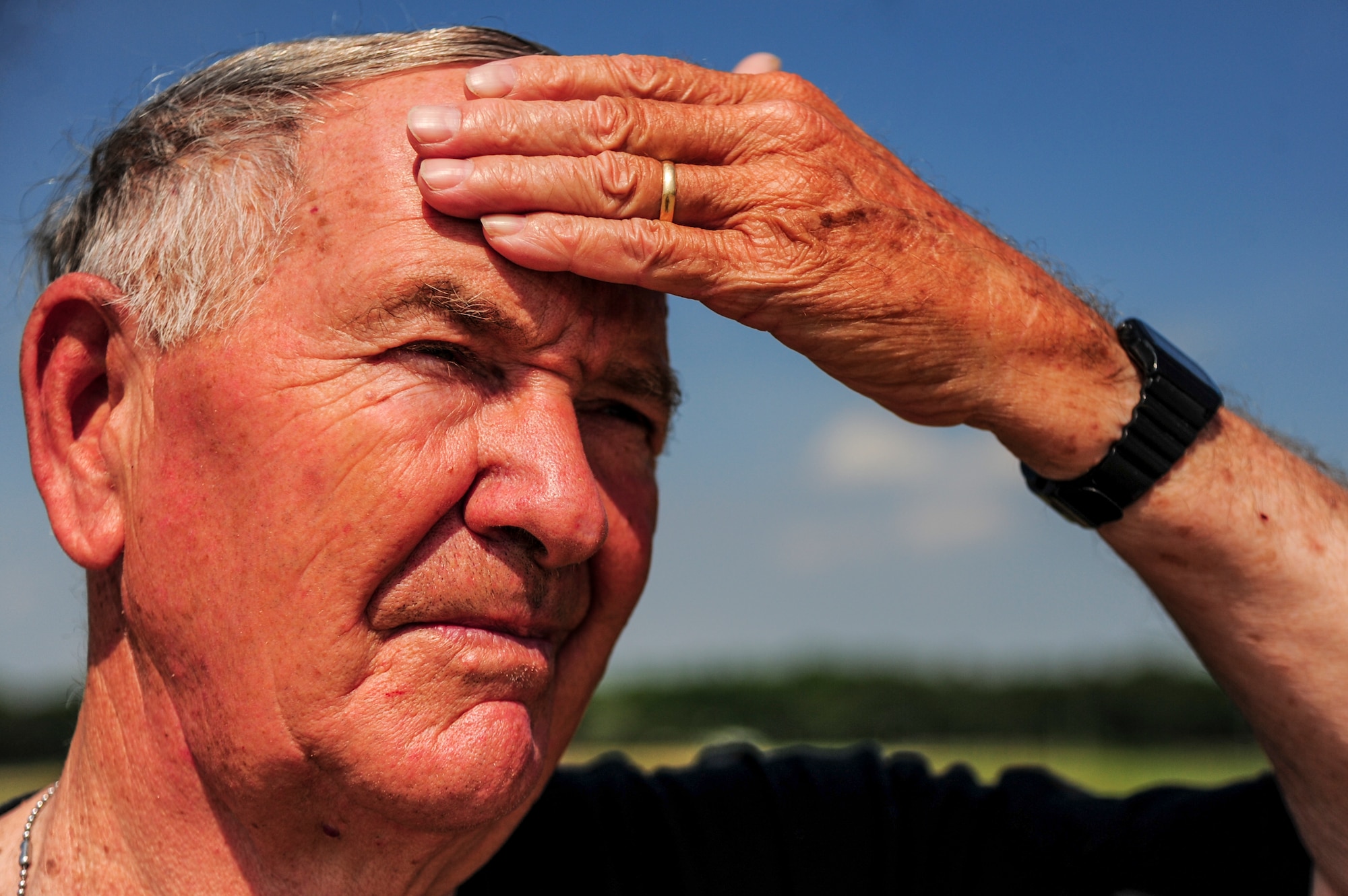 Retired U.S. Army Col. Walter “Joe” Marm wipes sweat from his brow after moving bails of hay, June 30, 2015, at a pig farm in Fremont, North Carolina. Marm and his wife own more than 50 acres of land in Fremont, all of which he helps maintain. (U.S. Air Force photo/Senior Airman Brittain Crolley)