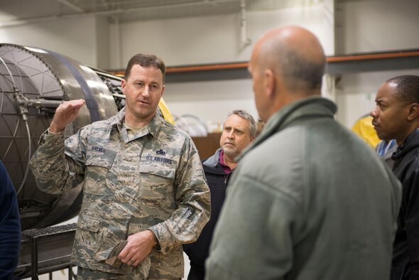 Capt. Wesley Sheppard, 366th Aircraft Maintenance Unit officer in charge, presents Maj. Gen. Glenn Davis, Air Force Life Cycle Management Center mobilization assistant to the commander, with the AMU coin and squadron t-shirt at Mountain Home Air Force Base, Idaho, Dec. 3, 2015. Davis came to see first-hand the capabilities of Mountain Home’s Strike Eagles. (U.S. Air Force photo by Senior Airman Malissa Lott/RELEASED)