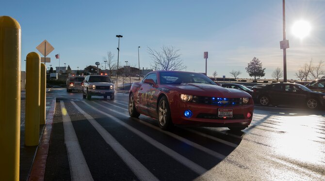 Law enforcement agencies arrive at a local shopping center for the final festivity of the day for the Shop with a Cop event, Dec. 5, 2015 in Mountain Home, Idaho. They convoyed through town and allowed children participating in the event to ride along. (U.S. Air Force photo by Airman 1st Class Connor J. Marth/Released)