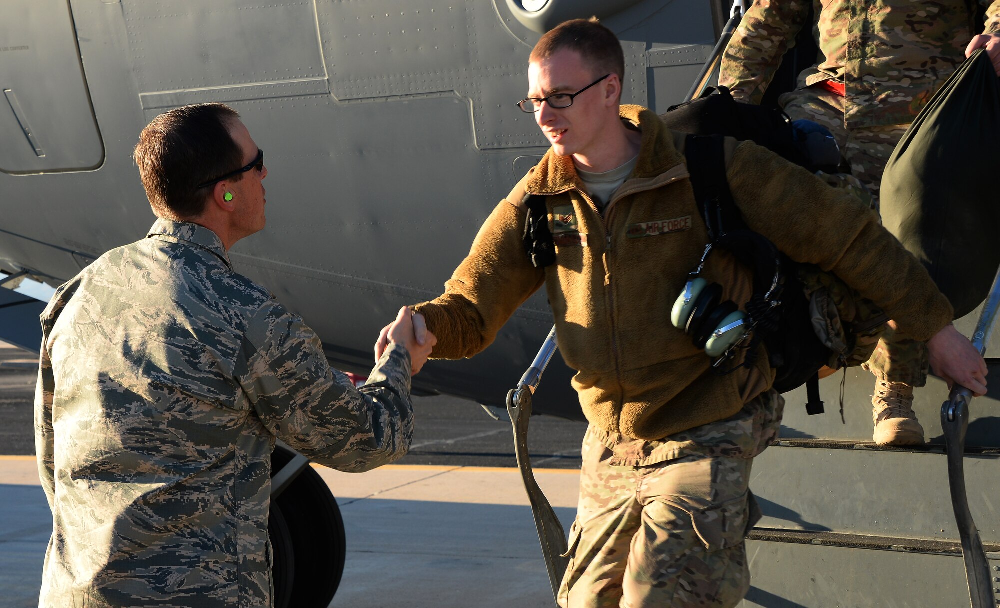 U.S. Air Force Col. James Meger, 355th Fighter Wing commander, welcomes back Senior Airman Timothy Thomasula, 923rd Aircraft Maintenance Squadron HC-130J Combat King II crew chief, as Thomasula returns to Davis-Monthan Air Force Base, Ariz., Dec. 7, 2015, from a deployment to Southwest Asia. Airmen were deployed in support of Operation Inherent Resolve. (U.S. Air Force photo by Airman 1st Class Mya M. Crosby/Released)