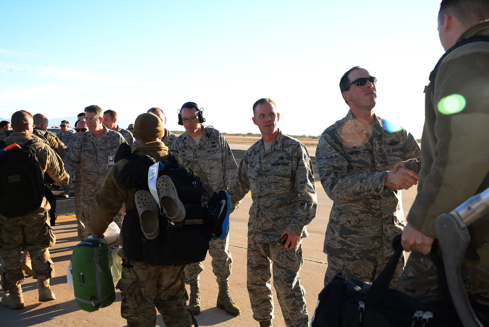 Desert Lightning Team leadership welcome back 563rd Rescue Group and 923rd Aircraft Maintenance Squadron Airmen as they return from deployment, Dec. 7, 2015 on the flightline at Davis-Monthan Air Force Base, Ariz. The Airmen were deployed to Southwest Asia in support of Operation Inherent Resolve. (U.S. Air Force photo by Airman 1st Class Mya M. Crosby/Released)