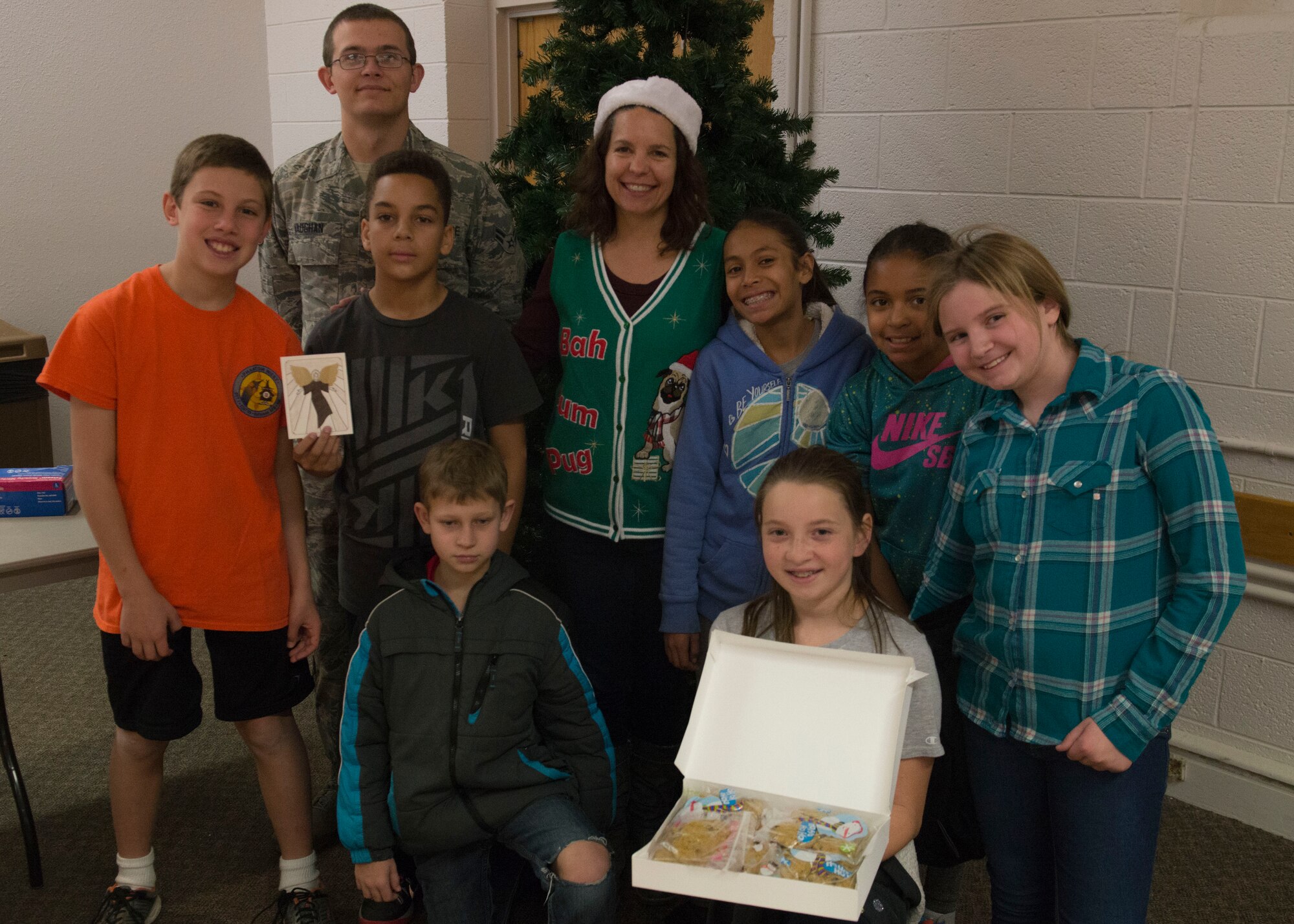 Students from Holloman Middle School gathered during the 2015 Holloman cookie drive to color holiday cards that would be attached to the bags of cookies delivered to Airmen living in dorm and lodging facilities at Holloman Air Force Base N.M., Dec 7. Holloman students were not the only ones who provided holiday cards. There were cards from Alamogordo schools attached to bags as well. (U.S. Air Force photo by Senior Airman Chase Cannon)