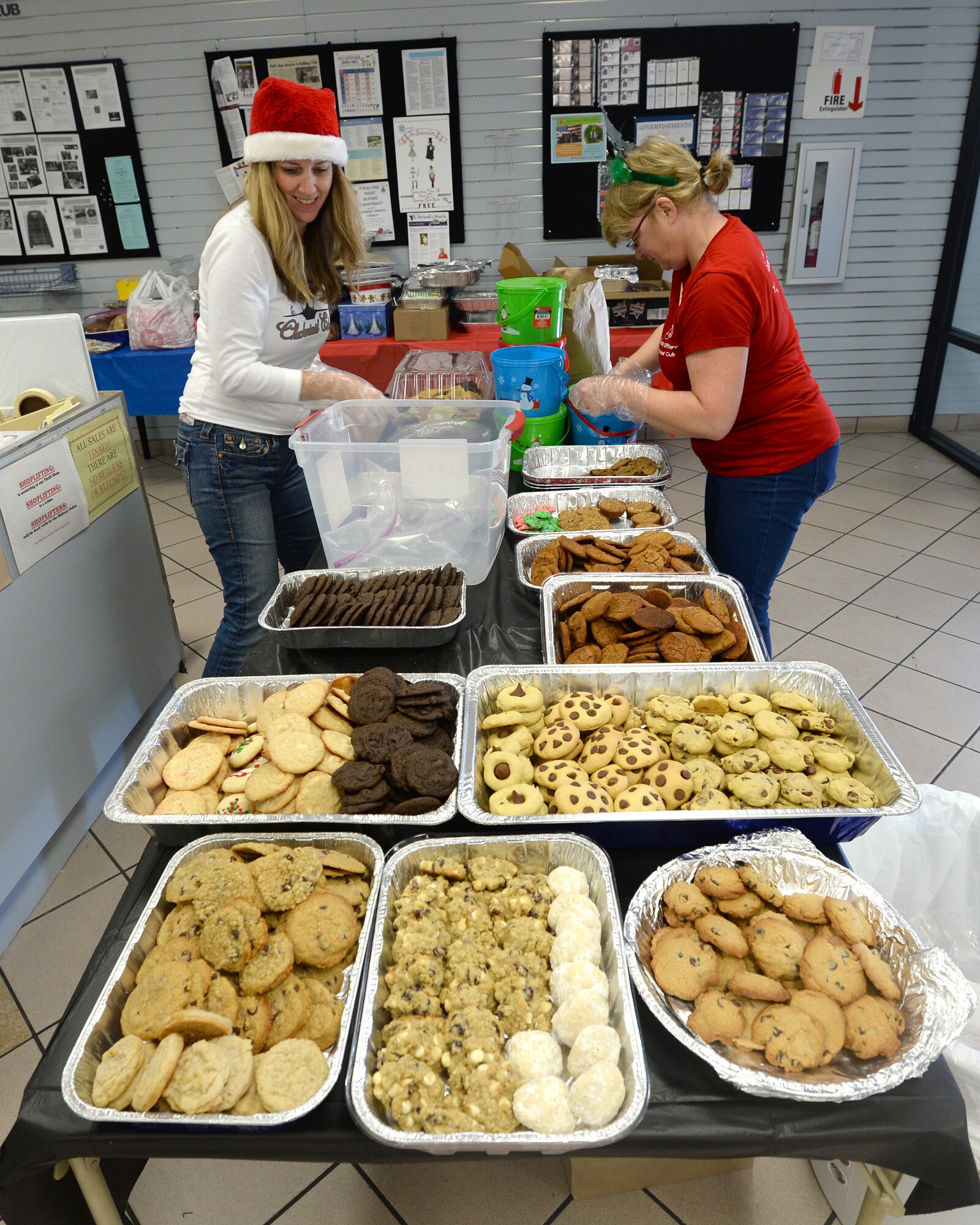 Volunteers from the Tyndall Officer Spouses Club and Enlisted Spouses Club collect and bag cookies for the Cookie Caper donation event.  Cookies were baked and donated from all over Tyndall to be given to Airmen that may miss their families for the holidays and need some extra cheer.  (U.S. Air Force photo by Airman 1st Class Miller/Released)