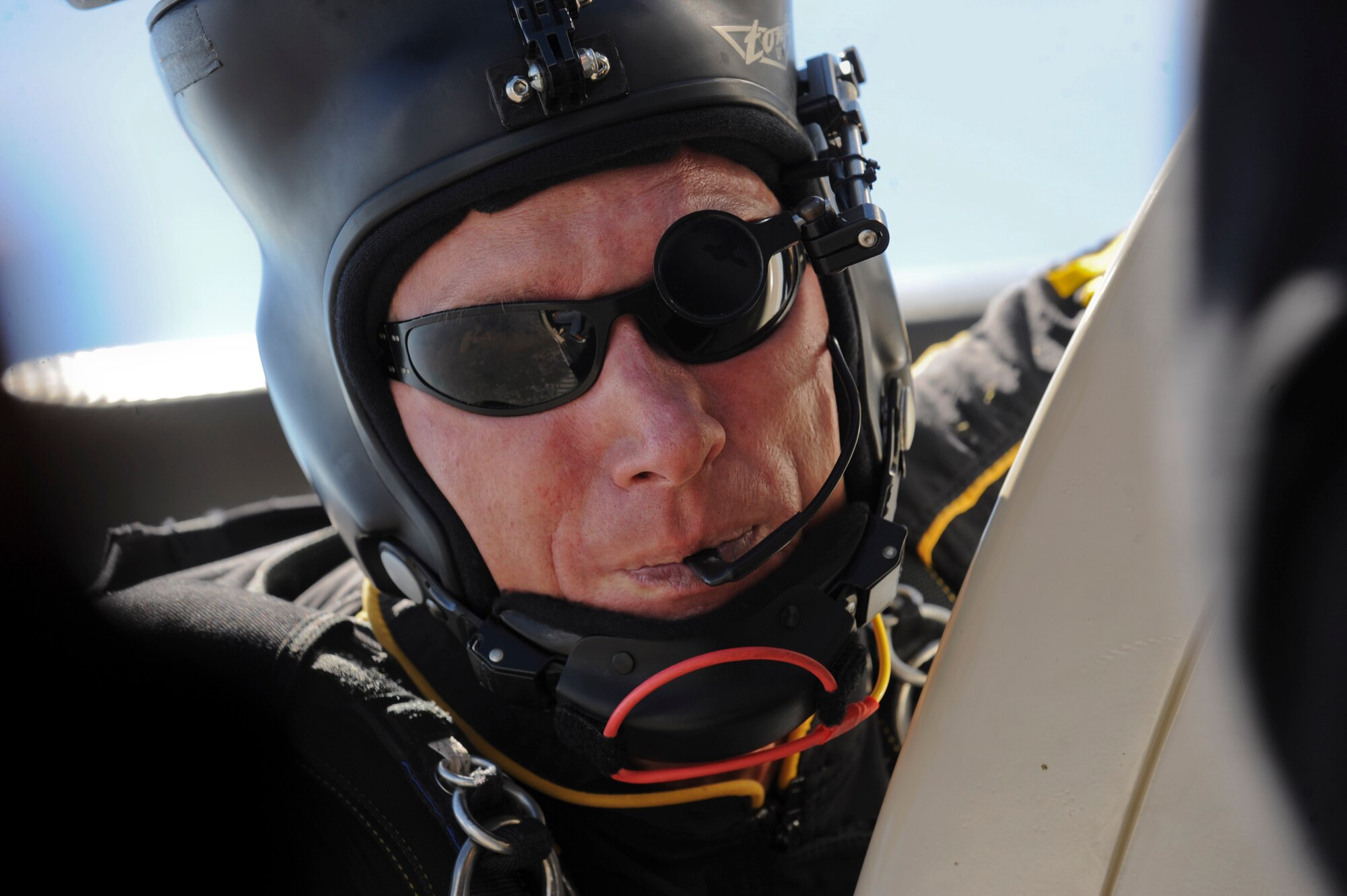 Sgt. 1st Class Adrian Hill, U.S. Army Golden Knights parachute team member, prepares to jump out of a C-31A Troopship during the 2015 Dakota Thunder air show and open house at Ellsworth Air Force Base, S.D., Aug. 15, 2015. The 12 man team executed a 10,000 foot jump to kick off the opening ceremonies of the event. (U.S. Air Force photo by Senior Airman Anania Tekurio/Released)