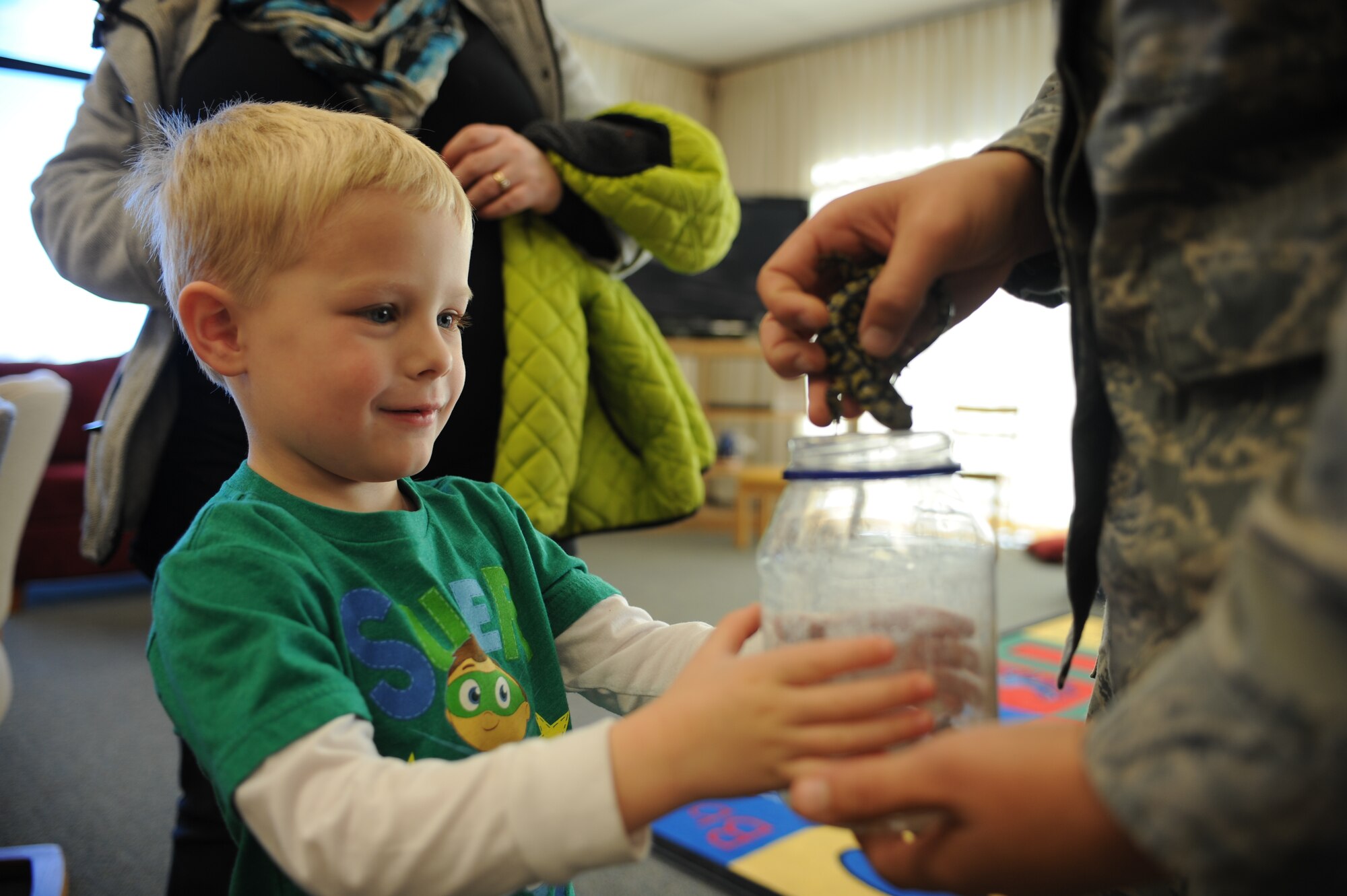 Nolan Trautner gets a closer look at a salamander while attending Little Warriors Story Time at the Holbrook Library at Ellsworth Air Force Base, S.D., Nov. 19, 2015. The library holds three programs that aim to equip children with knowledge and promote literacy and socialization. For more information about these and other library programs, call (605) 385-1688. (U.S. Air Force photo by Airman Sadie Colbert/Released)