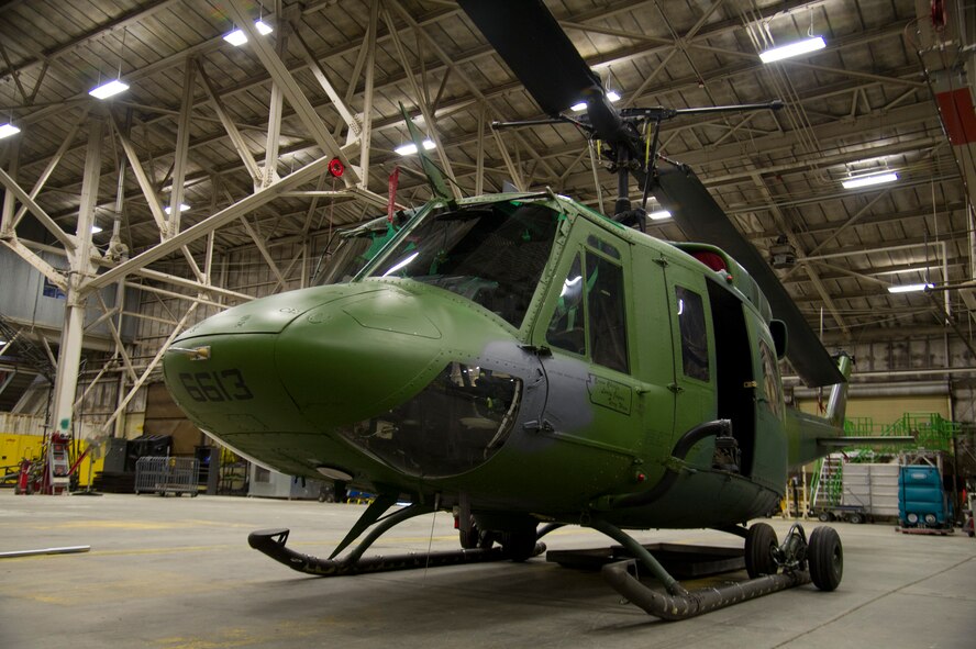 A UH-1N Iroquois helicopter sits in a hangar Nov. 6, 2015, at Fairchild Air Force Base, Wash. The 36th Rescue Squadron’s mission is to provide support for the Survival School. Their support includes: hoist and vector training, parachute operations, upgrade training for Survival, Evasion, Resistance and Escape specialists and the capabilities to perform civilian search and rescue. To date the rescue squadron has 689 saves. (U.S. Air Force photo/Airman 1st Class Nick J. Daniello)