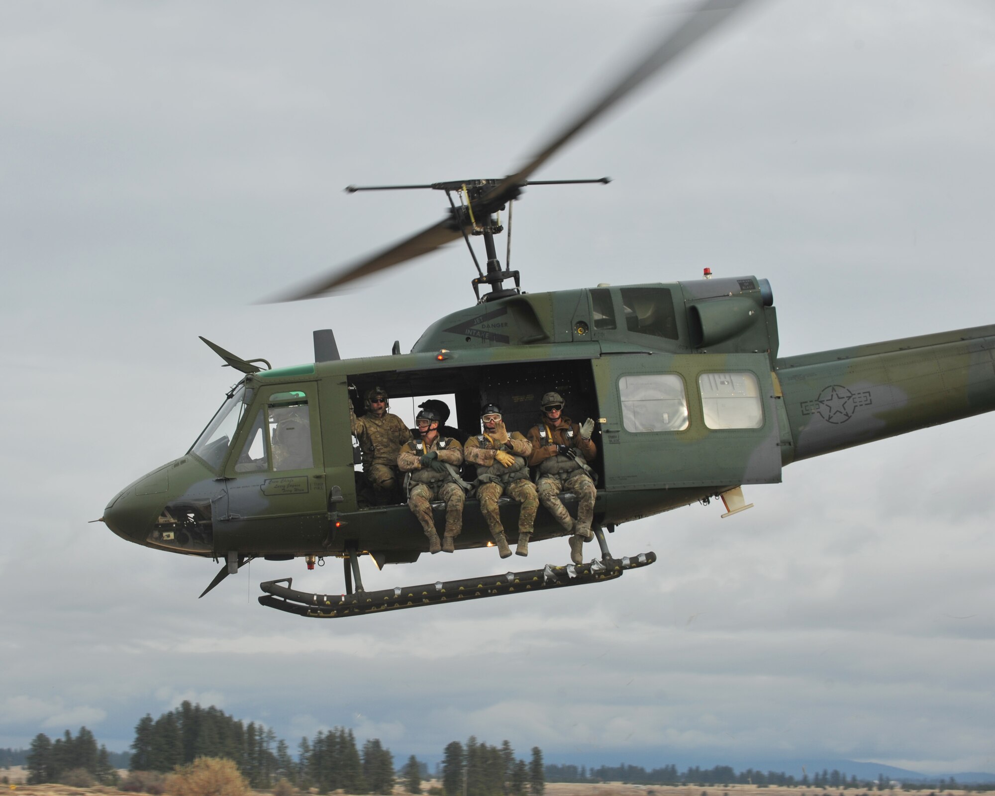 Survival Evasion Resistance and Escape Airmen from the 336th Training Group take off in a UH-1N Iroquois to practice weekly jumps to maintain their certifications and proficiency, Nov. 9, 2015 at Fairchild Air Force Base, Wash. The 36th Rescue Squadron provides the helicopter and hoist platform for a hands-on experience for both SERE specialists and combat survival students.  (U.S. Air Force photo/Staff Sgt. Samantha Krolikowski)