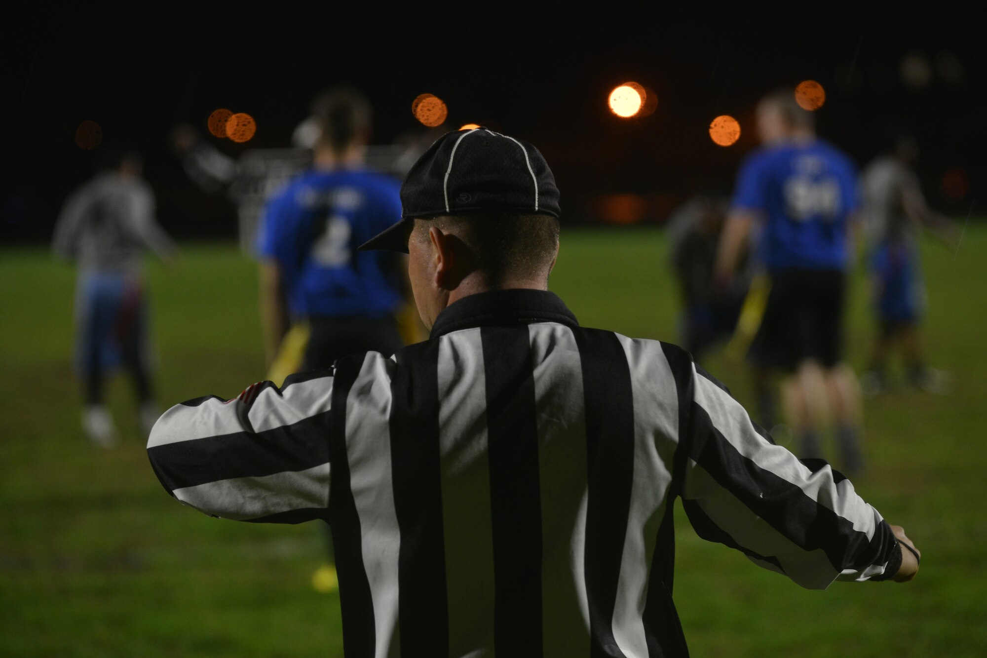 A referee checks the time after a play during the Joint Base Langley-Eustis flag football championship game at Fort Eustis, Va., Dec. 2, 2015.  The 633rd Force Support Squadron began scheduling championship games for various sporting events between the two installations this year in an effort to foster joint base growth. ( U.S. Air Force photo by Staff Sgt. Natasha Stannard)
