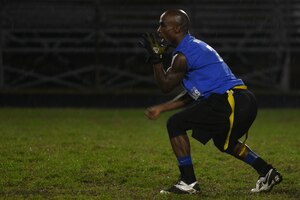 Gregory Smoots, a captain and quarterback for the Langley All-Star flag football team, signals to have the ball hiked during the Joint Base Langley-Eustis (JBLE) championship flag football game at Fort Eustis, Va., Dec. 2, 2015. This was the first flag football championship game between the two installations that make up JBLE. ( U.S. Air Force photo by Staff Sgt. Natasha Stannard)