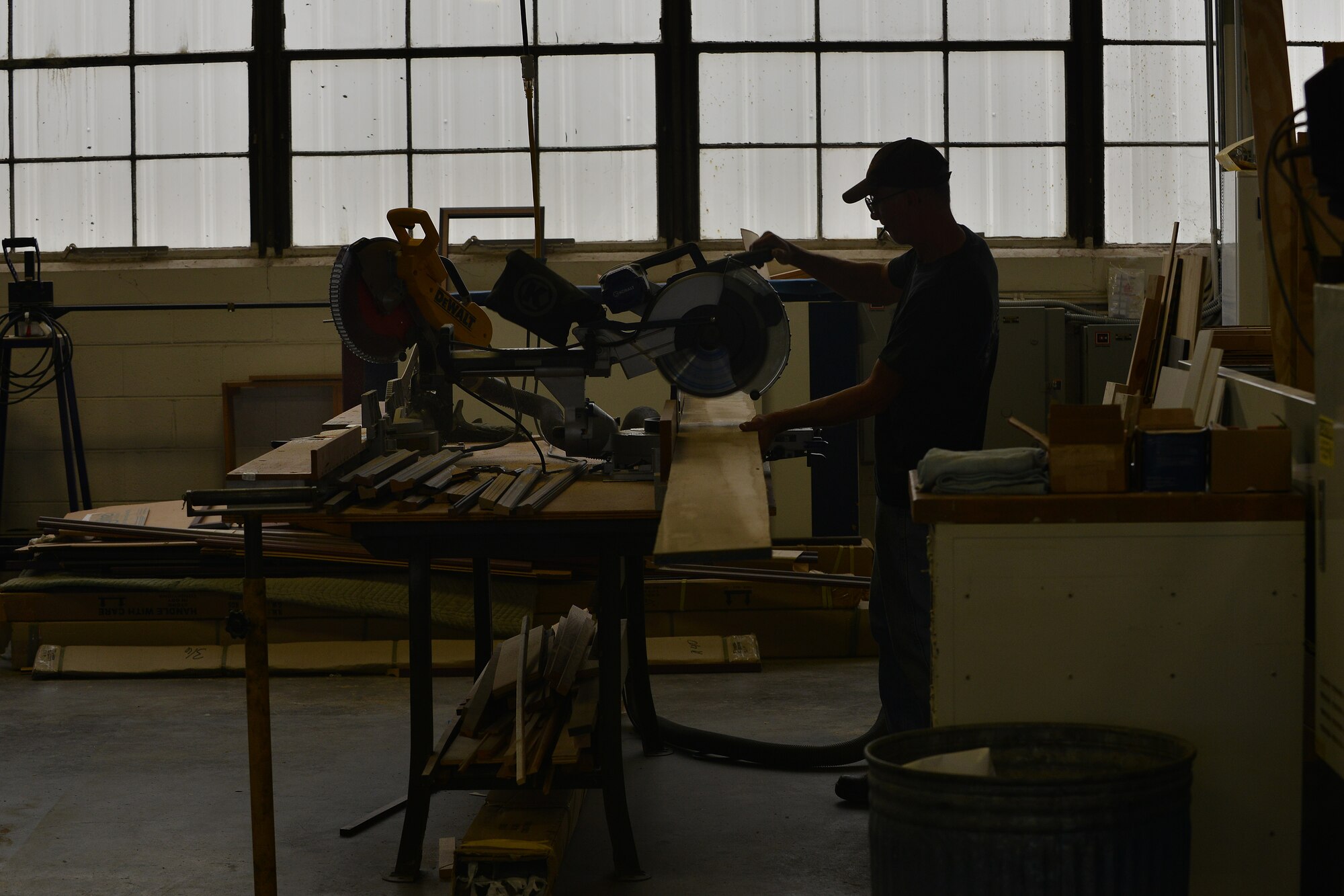 Ron Purvis, a fabrication specialist with the Joint Base Langley-Eustis Enterprise Multimedia Center (EMC), cuts wood for a crate at Fort Eustis, Va., Dec. 1, 2015. The fabrication section builds crates to deliver products to customers world-wide. (U.S. Air Force photo by Staff Sgt. Natasha Stannard)