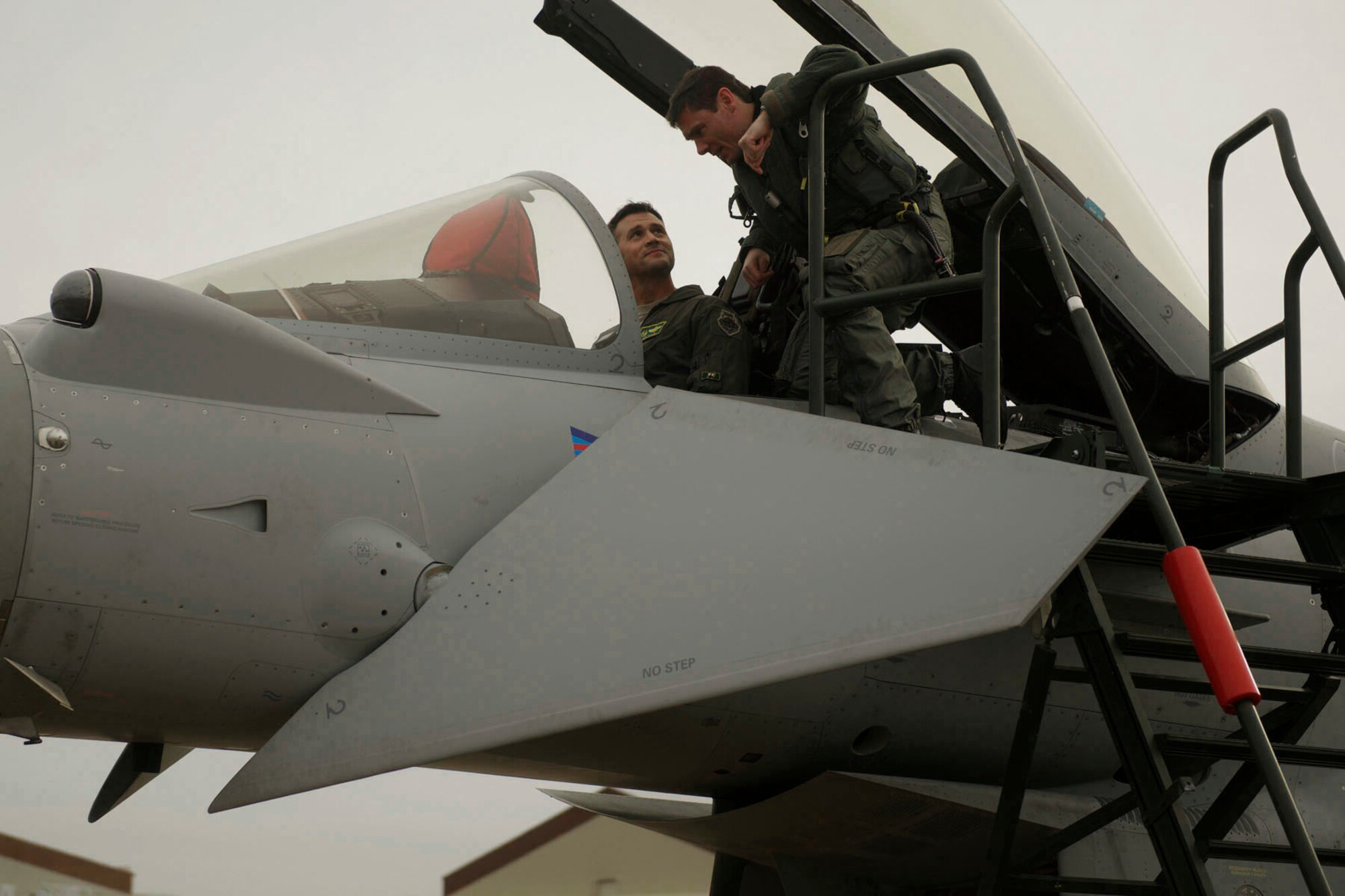U.S. Air Force Col. Pete Fesler, the commander of the 1st Fighter Wing, receives a tour of a British Royal Air Force (RAF) Typhoon cockpit at Langley Air Force Base, Va., Dec. 3, 2015. The Trilateral Exercise, which the RAF, U.S. Air Force and French air force are participating in, will be used for the allies to share and develop air tactics, techniques and procedures. (U.S. Air Force photo by Airman 1st Class Derek Seifert)