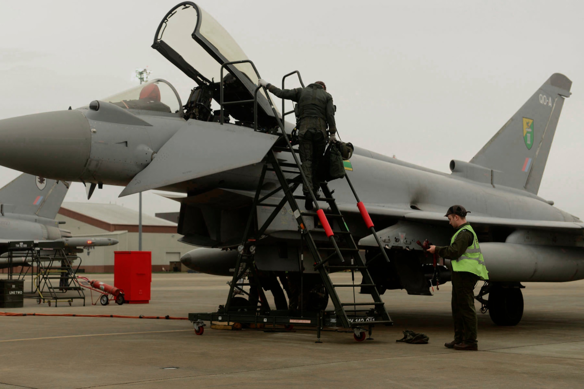 A British Royal Air Force (RAF) pilot climbs out of a cockpit after landing at Langley Air Force Base, Va., Dec. 3, 2015. The inaugural Trilateral Exercise provides U.S. Airmen and international partners an opportunity to experience realistic combat scenarios. (U.S. Air Force photo by Airman 1st Class Derek Seifert)