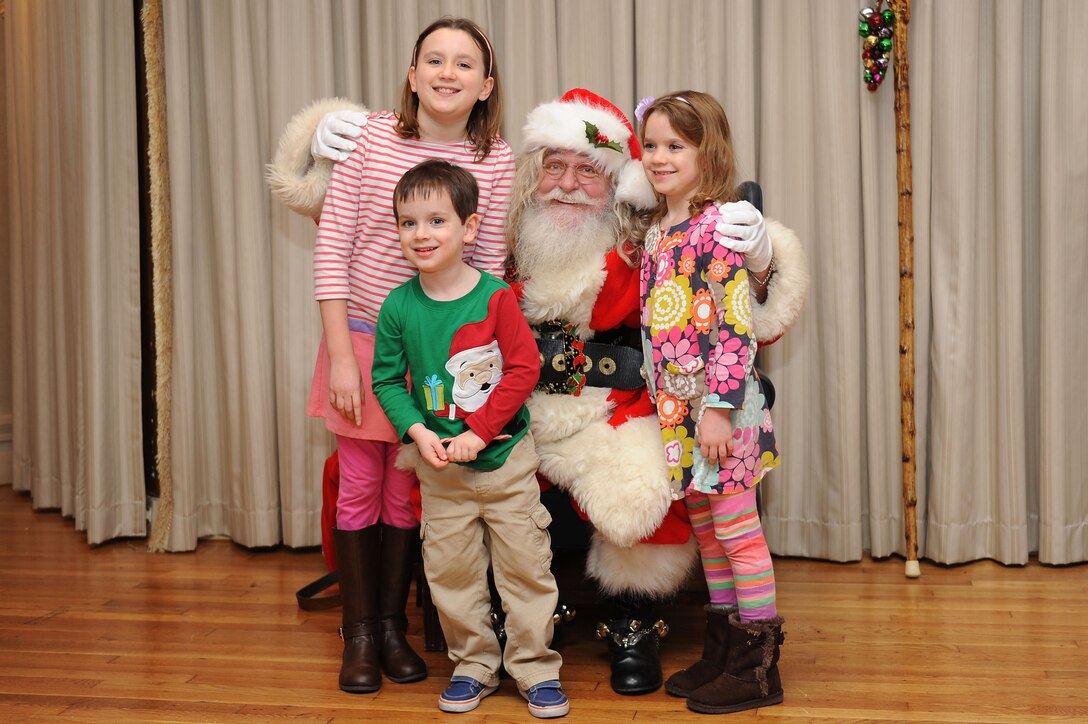 Children get their photo taken with Santa after the 48th annual Holiday Tree Lighting ceremony at Langley Air Force Base, Va., Dec. 8, 2015. Attendees were invited to the Langley Club following the ceremony for refreshments and a chance to meet Santa. (U.S. Air Force photo by Senior Airman Brittany E.N. Murphy)