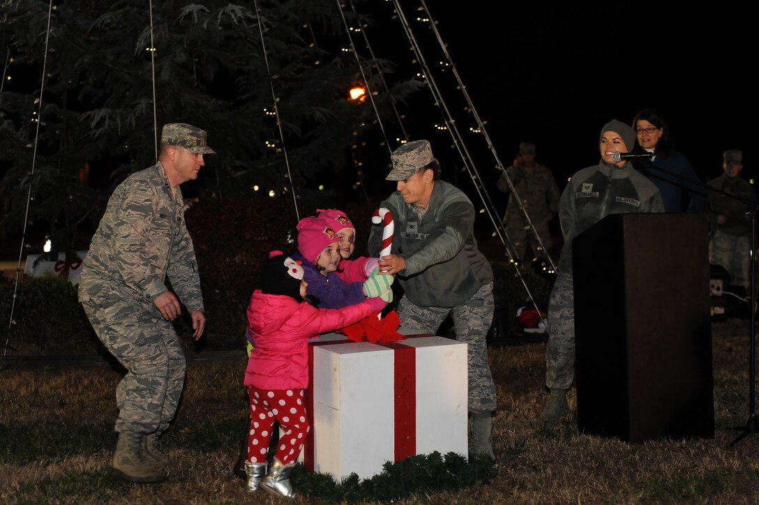 U.S. Air Force Col. Caroline M. Miller, the commander of the 633rd Air Base Wing, assists children with lighting the Holiday tree at Langley Air Force Base, Va., Dec. 8, 2015. This year marked the 48th annual tree lighting ceremony at Langley.  (U.S. Air Force photo by Senior Airman Brittany E.N. Murphy)
