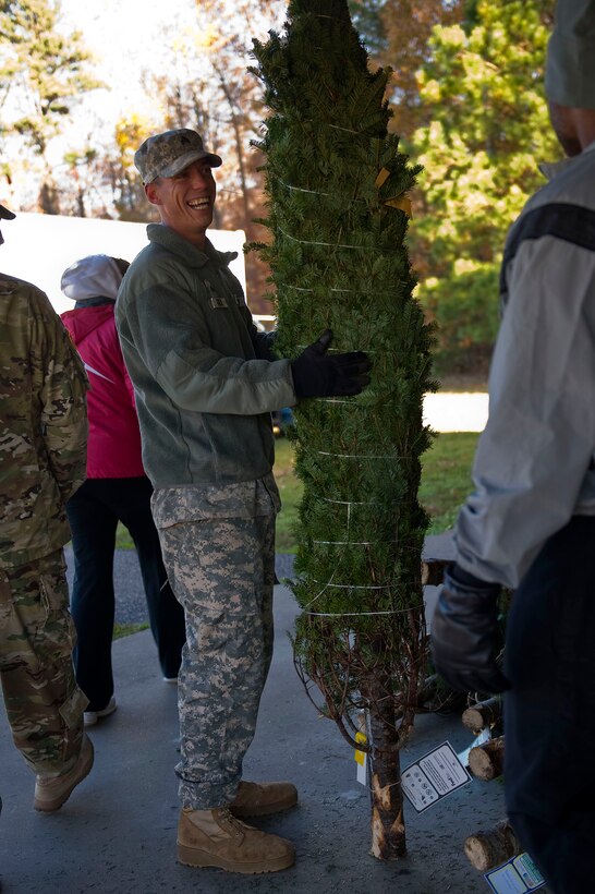 U.S. Army Sgt. Jacob Atkins, a leading seaman assigned to the 331st Transportation Company, picks out his Christmas tree at the Trees for Troops event at Fort Eustis, Va., Dec. 4, 2015. The event, which supplied free trees to military members and their families, was open to all active-duty Service members and their dependents. (U.S. Air Force photo by Senior Airman Breonna Veal)