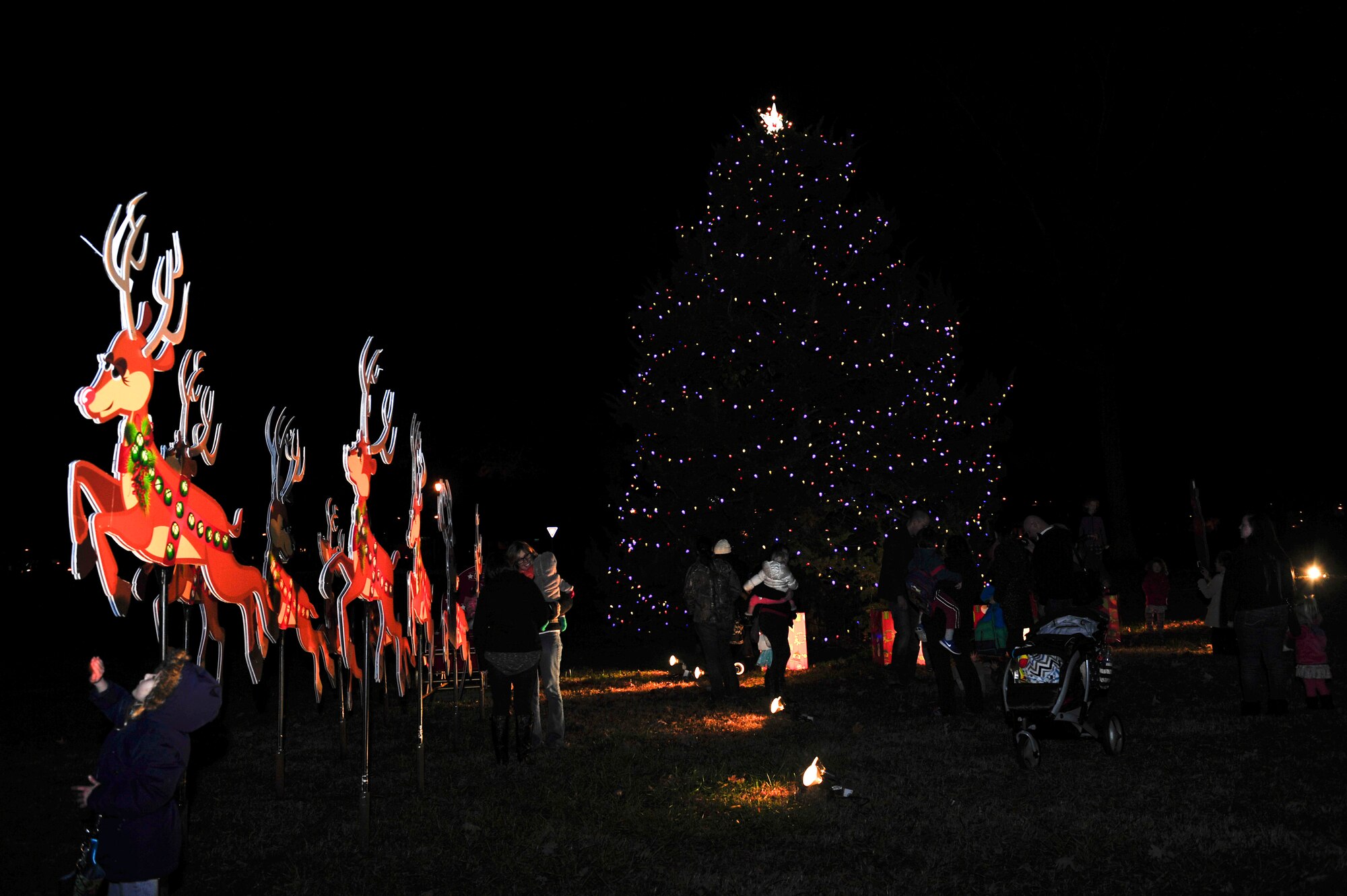 U.S. Service members and their families view the Holiday tree at Seay Plaza at Fort Eustis, Va., Dec. 4, 2015. More than 200 U.S. Service members and their families came out to enjoy the holiday festivities. (U.S. Air Force photo by Senior Airman Breonna Veal)